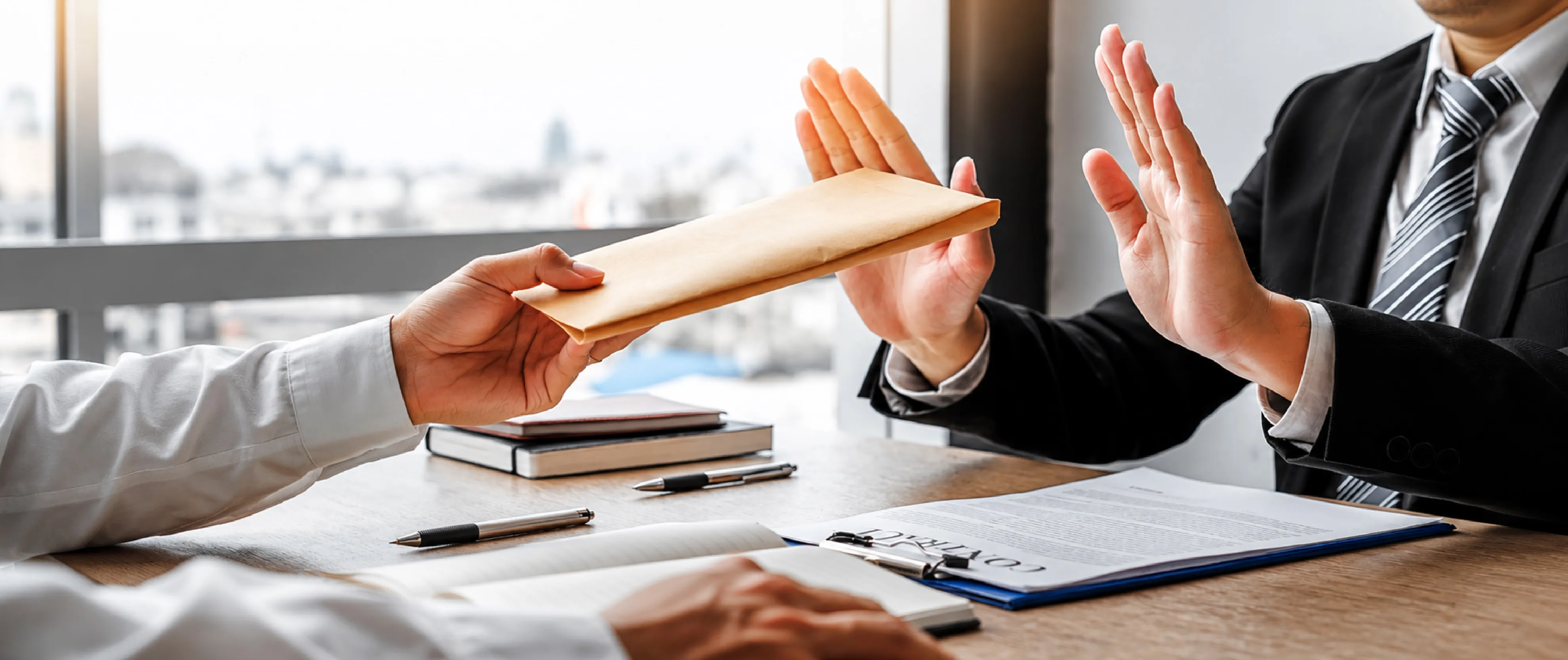 Corporate executive rejecting a bribe envelope during a business meeting, representing anti-bribery compliance, ethical business practices, and ISO 37001 anti-corruption standards.